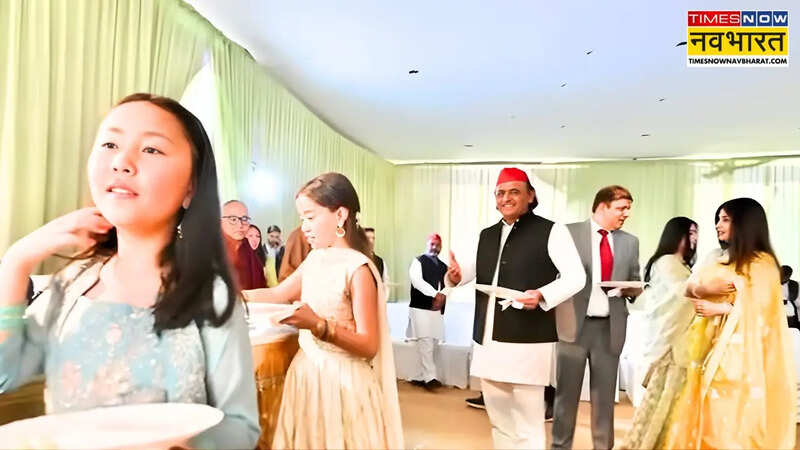 Akhilesh Yadav and his wife Dimple Yadav were seen standing in line with plates of food.