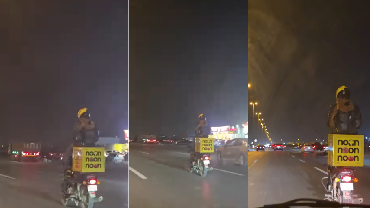 Viral Video: डिलीवरी बॉक्स पर बैठकर अनोखे अंदाज में बाइक चला रहा था शख्स, नजारा देखकर दंग रह जाएंगे